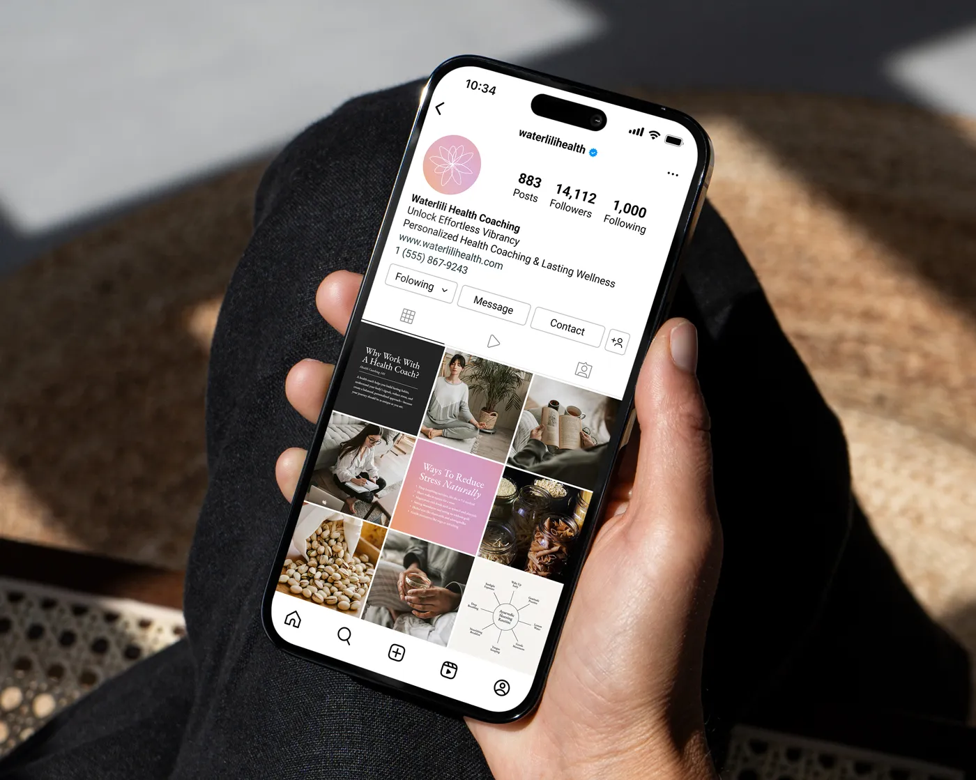 A hand holding a smartphone displaying the Instagram profile for Waterlili Health Coaching. The profile highlights a pastel flower logo, bio, contact info, and a 3x3 grid of wellness-themed posts, including content on working with a health coach, stress reduction, nutrition, and lifestyle tips.